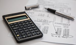 calculator on table financial cost - instant payday loans