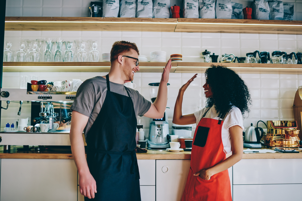 Retail Workers High-Fiving - Cigno Loans