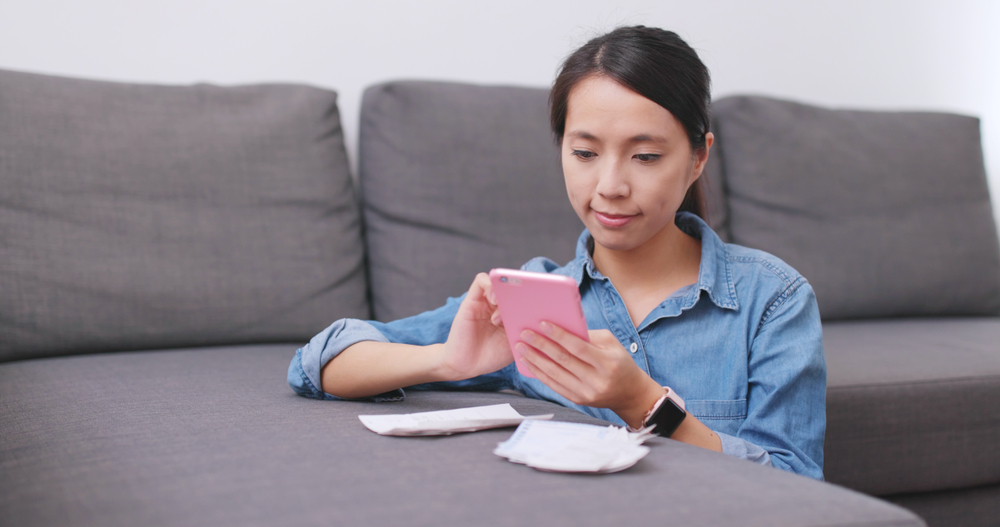 Woman Photographing Receipts - Cigno Loans